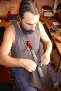 scrapeing violin finger board at Violin makers workshop QLD
