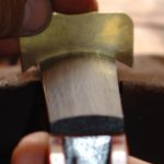 Ilja Grawert Violin maker checking the Fingerboard curve in his Brisbane Violin shop